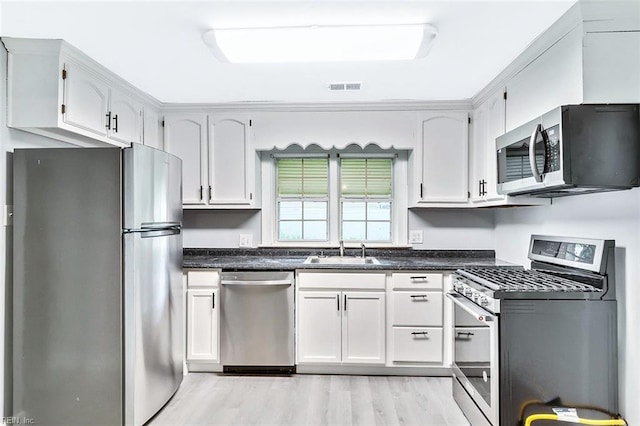 913 Garfield Ave, Suffolk, VA 23434 - kitchen with visible vents, appliances with stainless steel finishes, a sink, white cabinets, and light wood-style flooring