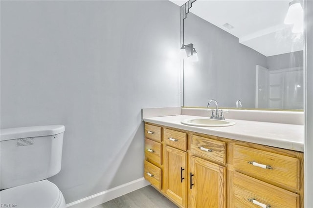 913 Garfield Ave, Suffolk, VA 23434 - bathroom with toilet, baseboards, wood finished floors, and vanity