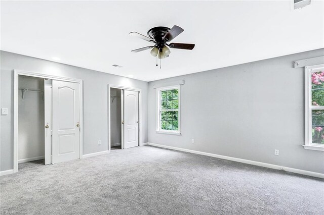 913 Garfield Ave, Suffolk, VA 23434 - unfurnished bedroom with baseboards, carpet flooring, multiple closets, and visible vents