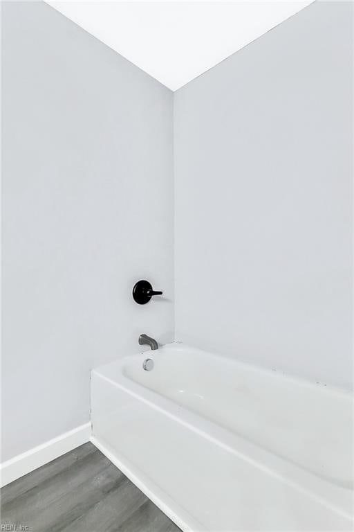 913 Garfield Ave, Suffolk, VA 23434 - full bathroom with baseboards, wood finished floors, and a bath