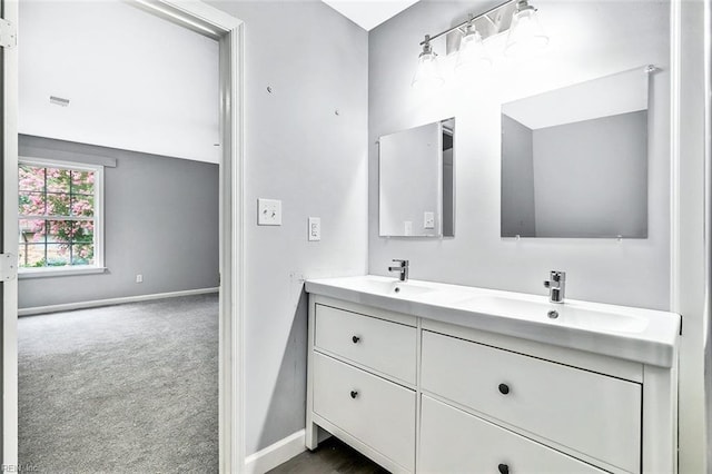 913 Garfield Ave, Suffolk, VA 23434 - bathroom featuring double vanity, baseboards, and a sink
