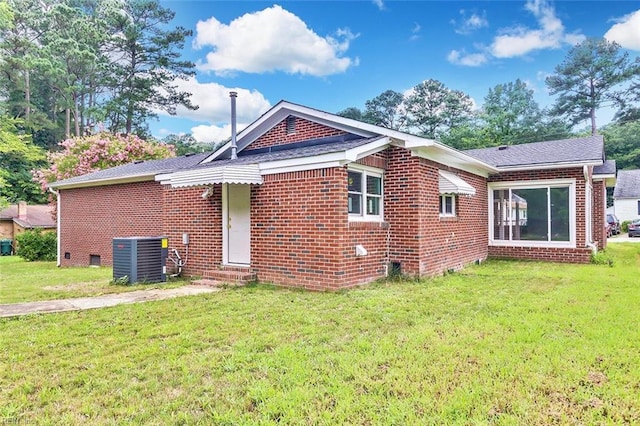 913 Garfield Ave, Suffolk, VA 23434 - exterior space featuring a yard, brick siding, and central AC unit