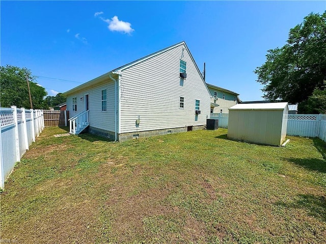view of side of property featuring a storage unit, a fenced backyard, a lawn, and central air condition unit