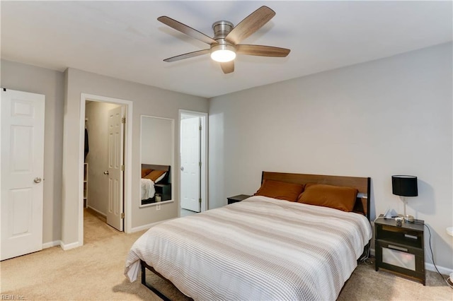 bedroom featuring light colored carpet, a ceiling fan, and baseboards