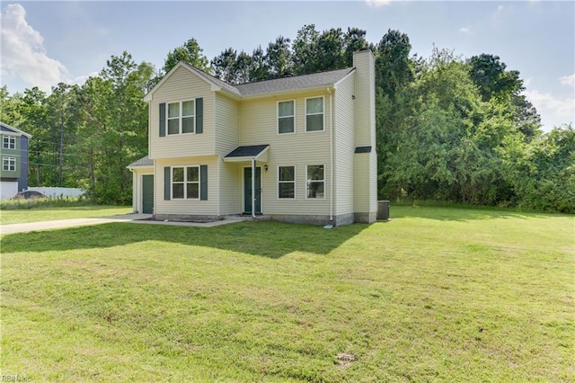 view of front of house featuring a garage, a front yard, and a chimney