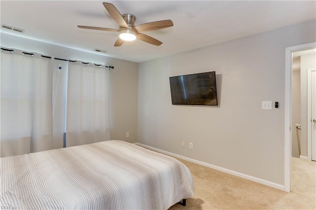 bedroom featuring baseboards, ceiling fan, light colored carpet, and visible vents