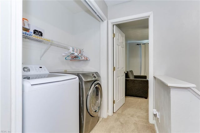 laundry room featuring separate washer and dryer, laundry area, and light colored carpet