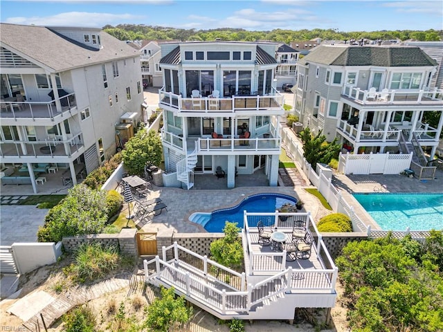 view of pool with stairway, a deck, a fenced in pool, and a fenced backyard