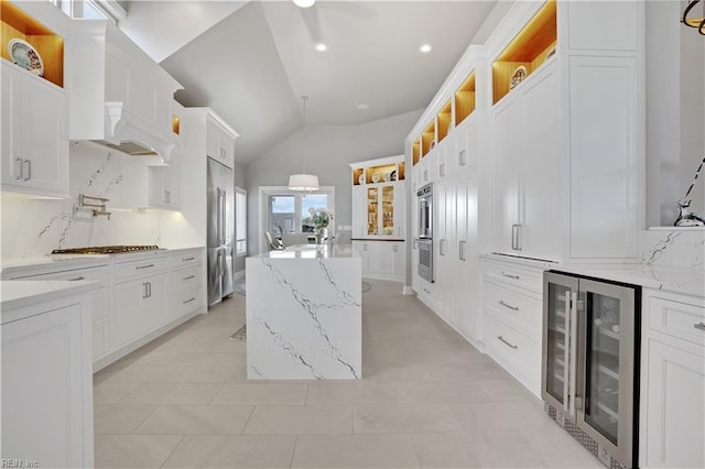 kitchen with open shelves, a center island, white cabinetry, lofted ceiling, and wine cooler