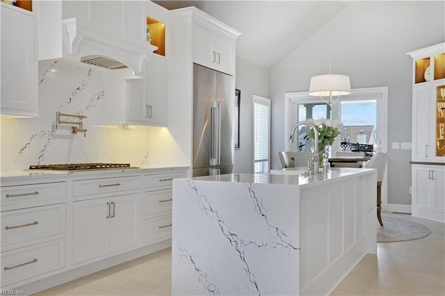 kitchen with a center island with sink, white cabinetry, tasteful backsplash, custom range hood, and stainless steel appliances