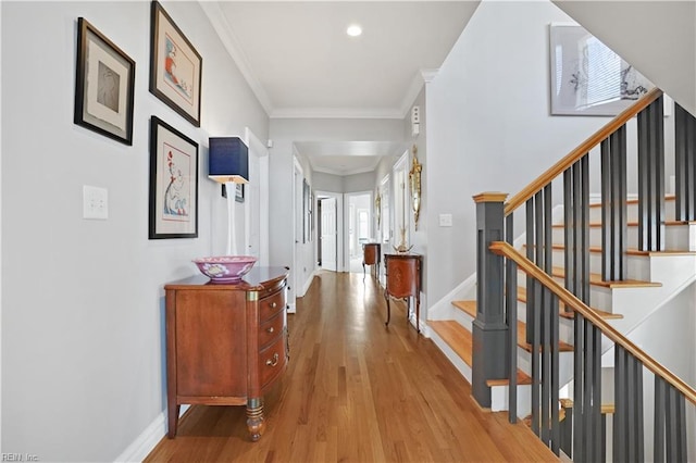 hall with stairs, baseboards, and wood finished floors