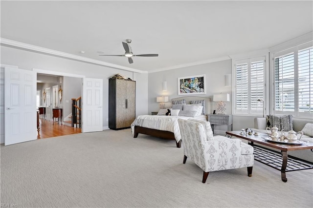 bedroom with carpet flooring, a ceiling fan, baseboards, and ornamental molding