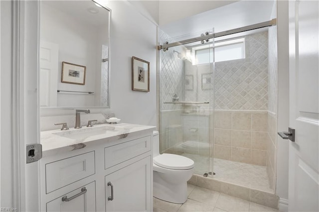 full bath featuring vanity, toilet, tile patterned floors, and a stall shower