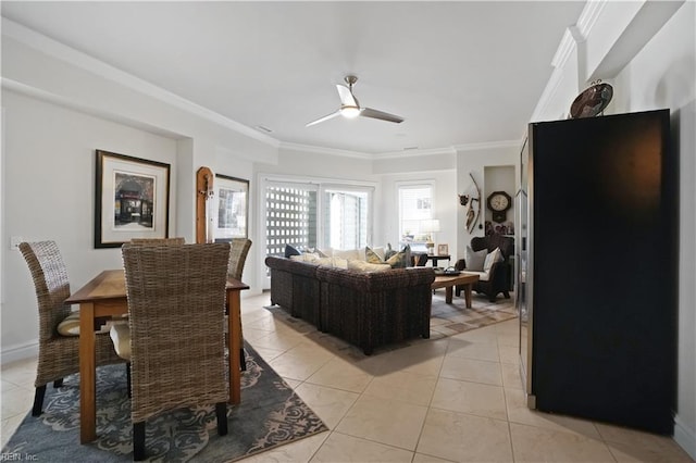 living area featuring crown molding, baseboards, a ceiling fan, and light tile patterned flooring
