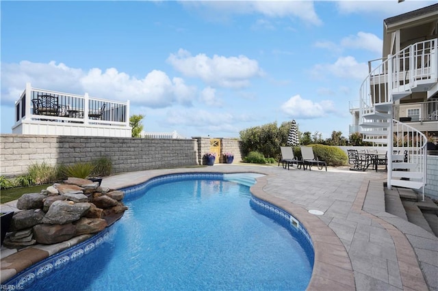 view of swimming pool featuring a fenced in pool, fence, and a patio