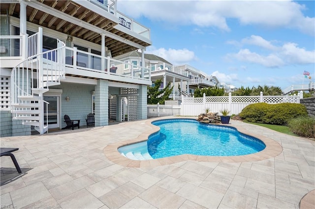 view of swimming pool with a fenced backyard, a fenced in pool, stairs, and a patio area