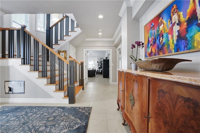 foyer featuring ornamental molding, light tile patterned flooring, baseboards, stairway, and recessed lighting