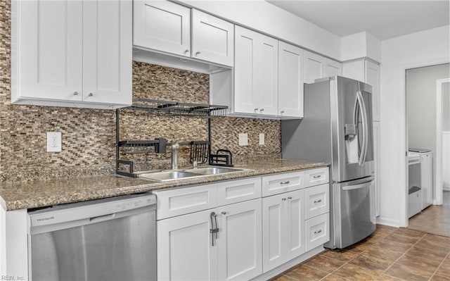 kitchen featuring a sink, appliances with stainless steel finishes, white cabinets, and backsplash