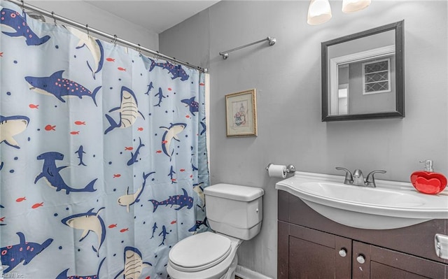 bathroom with vanity, curtained shower, and toilet