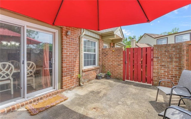 view of patio / terrace featuring a gate and fence