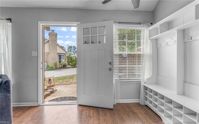 mudroom with baseboards, a ceiling fan, and wood finished floors