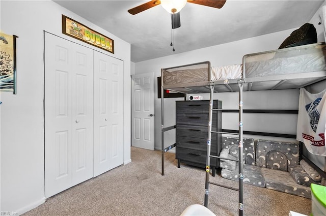 bedroom featuring a ceiling fan, carpet, and a closet