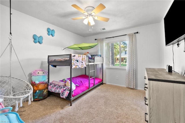 carpeted bedroom with baseboards and ceiling fan