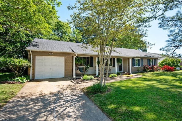 ranch-style house with brick siding, a garage, a front lawn, and concrete driveway