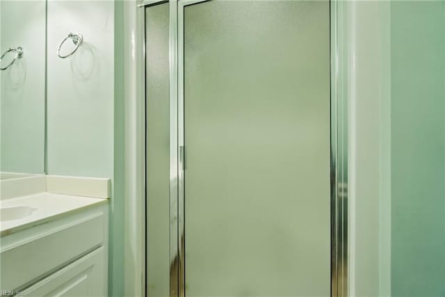 full bath featuring vanity and a stall shower