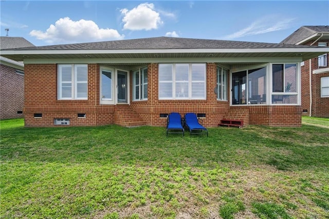 rear view of house with a lawn, crawl space, and a sunroom