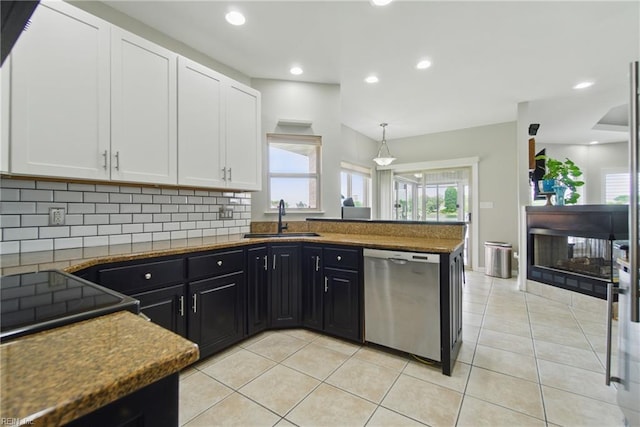 kitchen with dishwasher, white cabinetry, dark cabinets, a sink, and backsplash