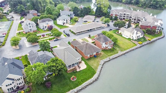 drone / aerial view with a water view and a residential view