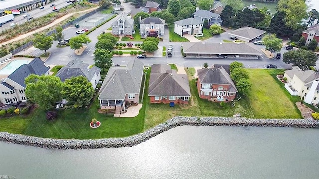 birds eye view of property with a water view and a residential view