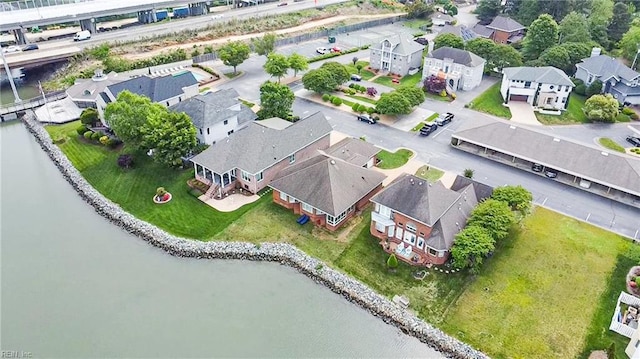 drone / aerial view featuring a water view and a residential view