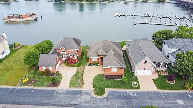 birds eye view of property with a water view and a residential view