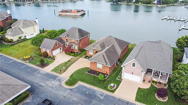bird's eye view featuring a water view and a residential view