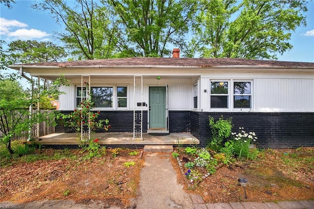 1 Polaris St, Hampton, VA 23669 - view of front of property with a porch, brick siding, and a chimney