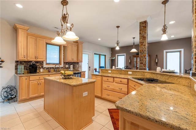 kitchen featuring backsplash, black electric stovetop, a wealth of natural light, and light brown cabinets