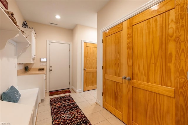 interior space with light tile patterned flooring, visible vents, and recessed lighting
