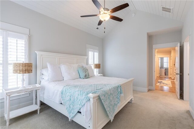 bedroom featuring visible vents, ceiling fan, high vaulted ceiling, and light colored carpet