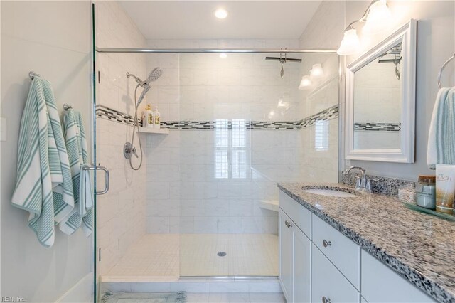 bathroom featuring vanity, a shower stall, and recessed lighting