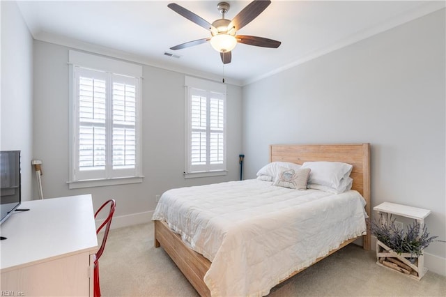 bedroom featuring carpet floors, ornamental molding, visible vents, baseboards, and a ceiling fan