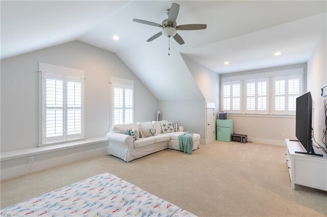 interior space with ceiling fan, a wealth of natural light, and light carpet