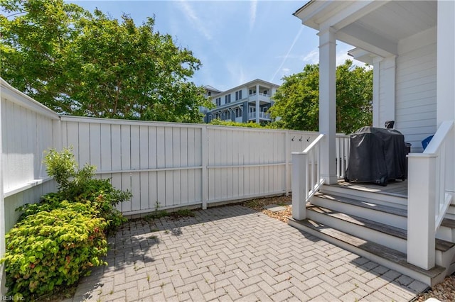 view of patio with fence and area for grilling