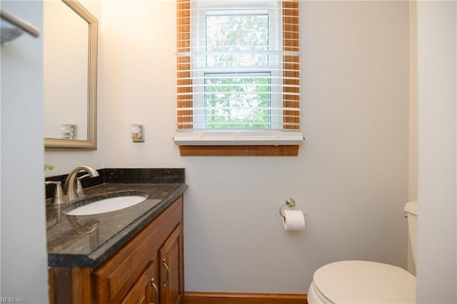 bathroom featuring toilet and vanity