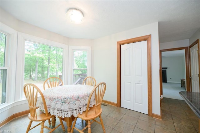 dining area featuring baseboards and light tile patterned floors