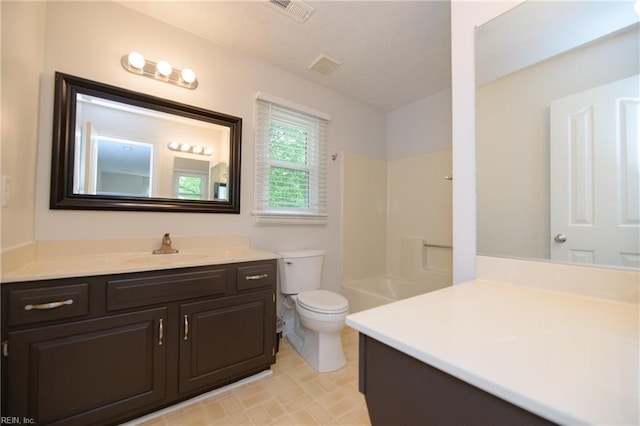 bathroom featuring vanity, toilet, visible vents, and a shower