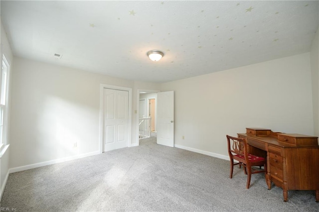 carpeted office space featuring baseboards