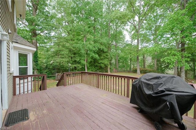 wooden deck featuring a grill