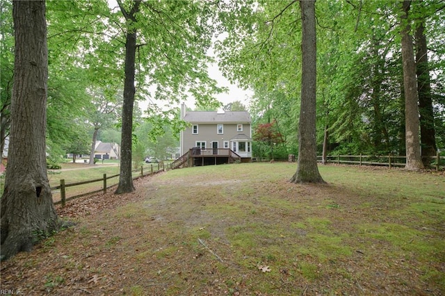 view of yard featuring stairway, fence, and a deck